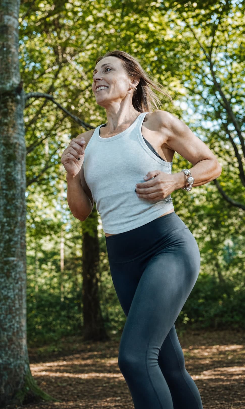 Strong mature woman running outdoors